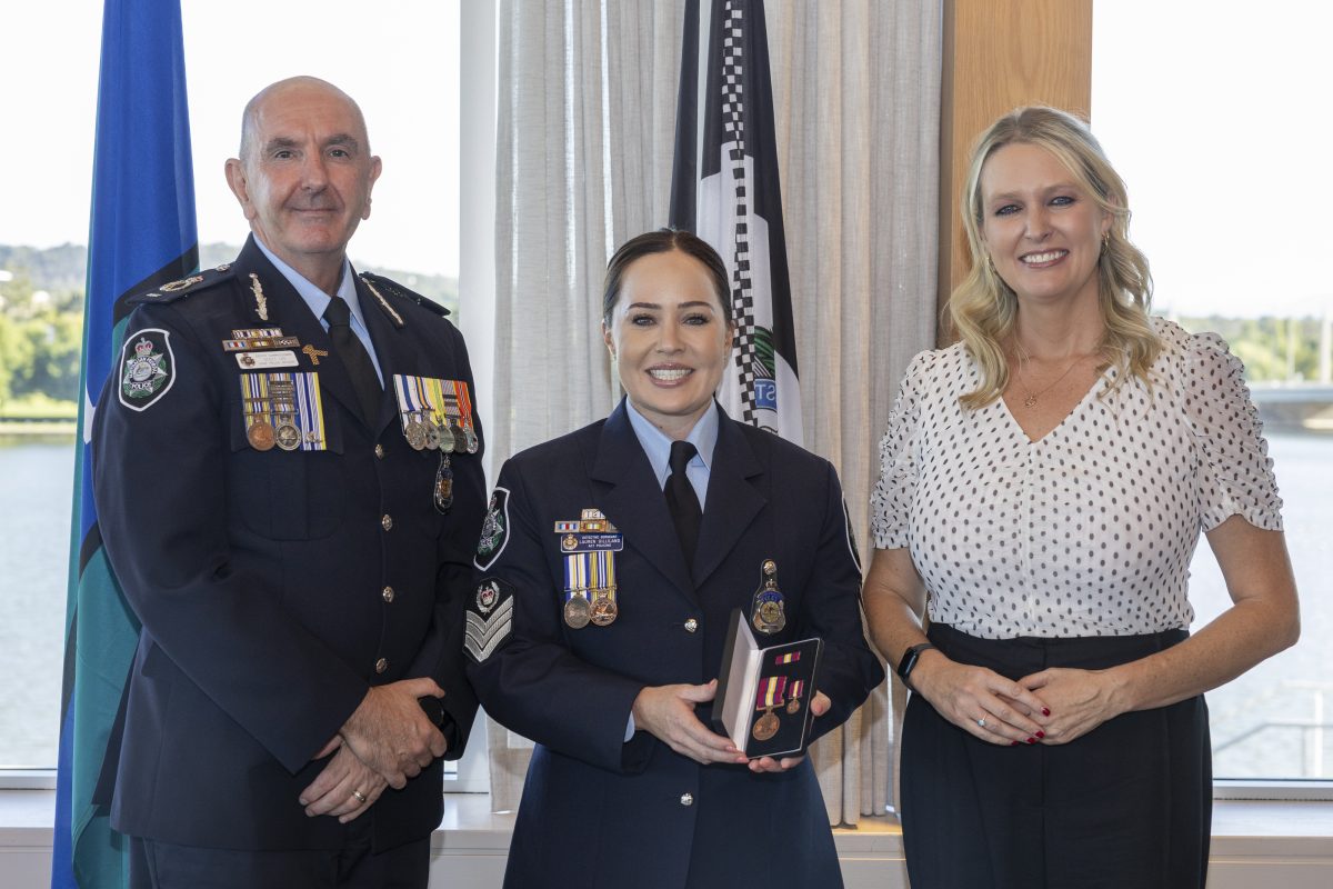 policeman, policewoman with medals and civilian