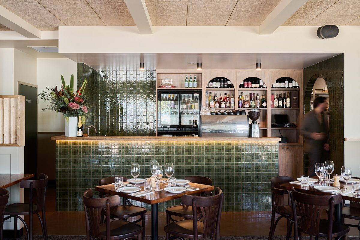 Restaurant counter with bar behind.