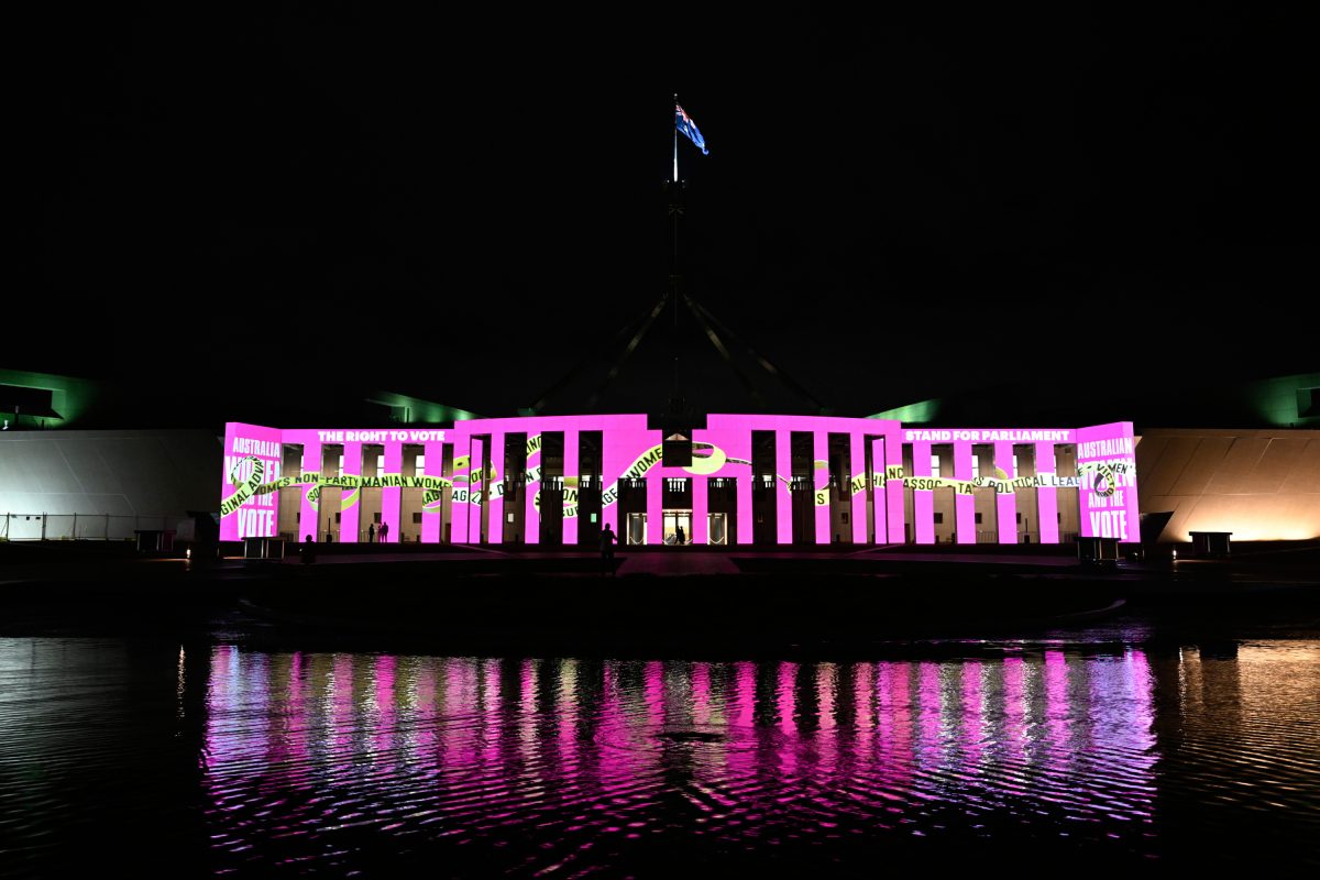 Parliament House illuminated in coloured light for an artwork