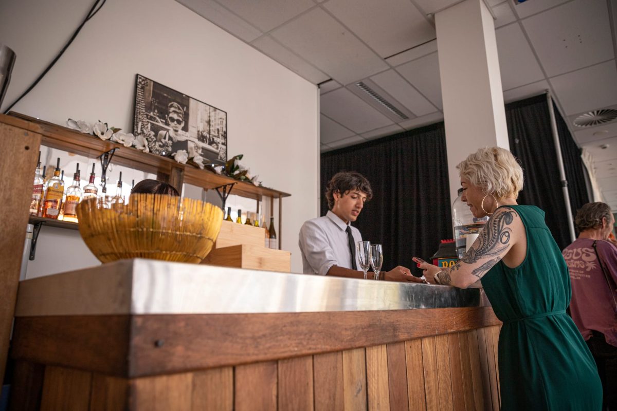 A woman being served at a bar