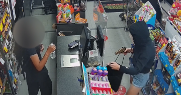 WATCH: Alleged gun-toting robber filmed stealing cash at supermarket