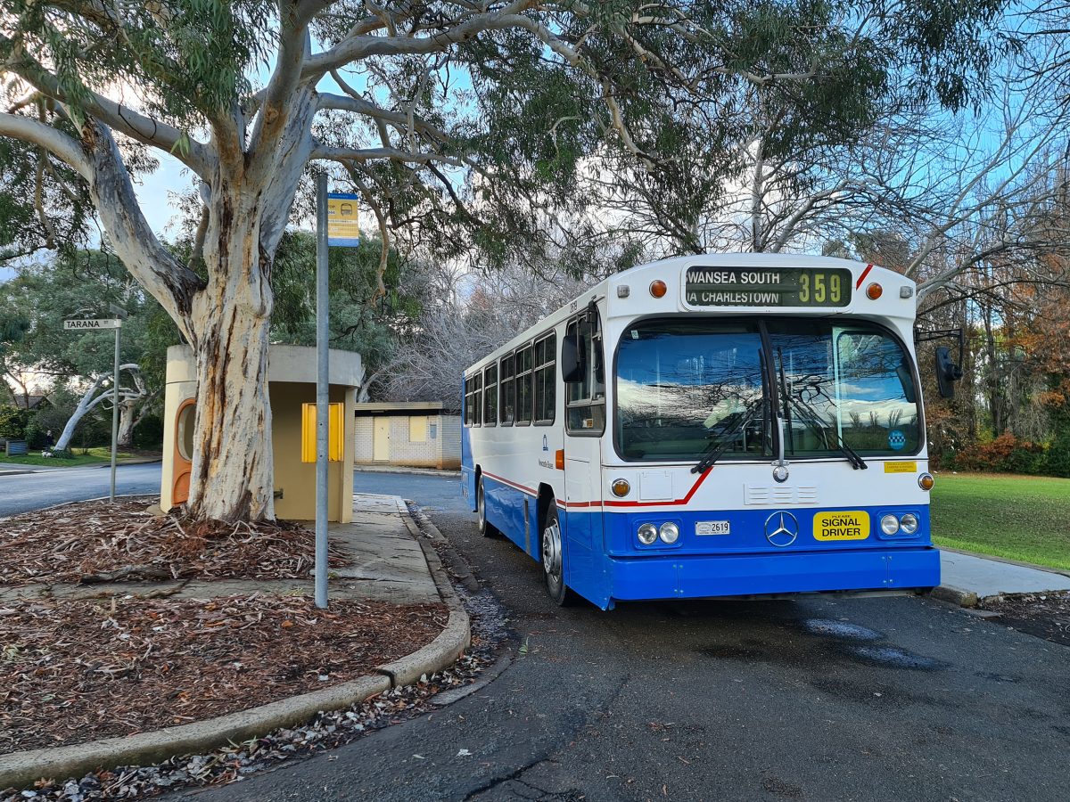 Bus stopped by a bus shelter