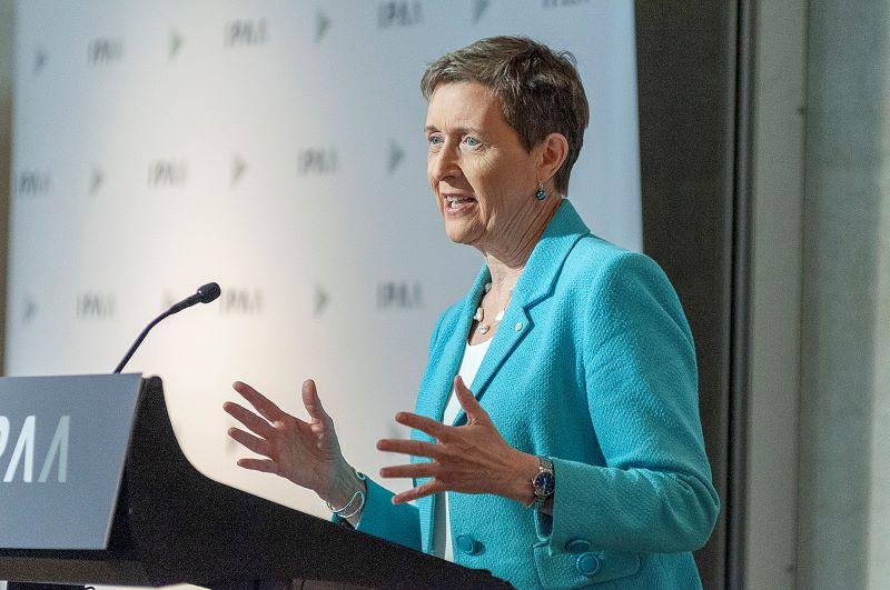 woman speaking at lectern