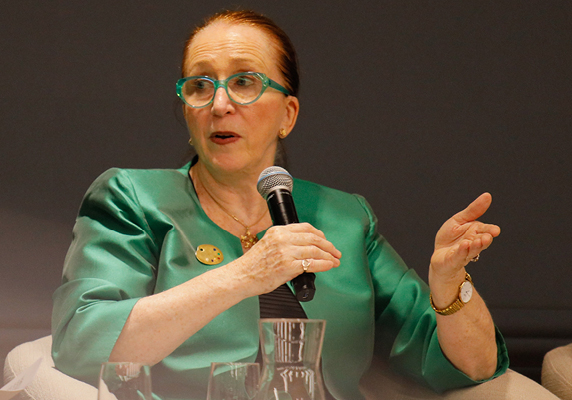 Woman speaking into a microphone at a function