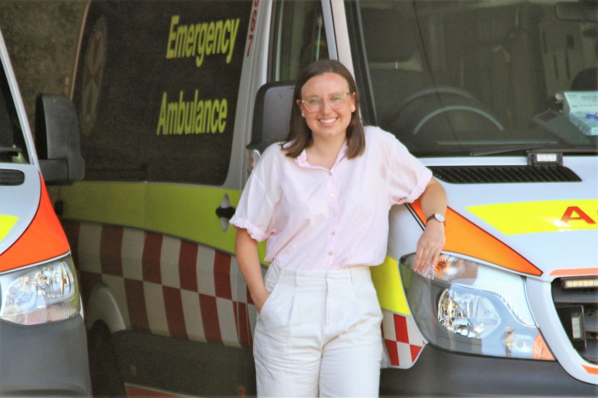 Madeleine Juhrmann standing in front of an ambulance.
