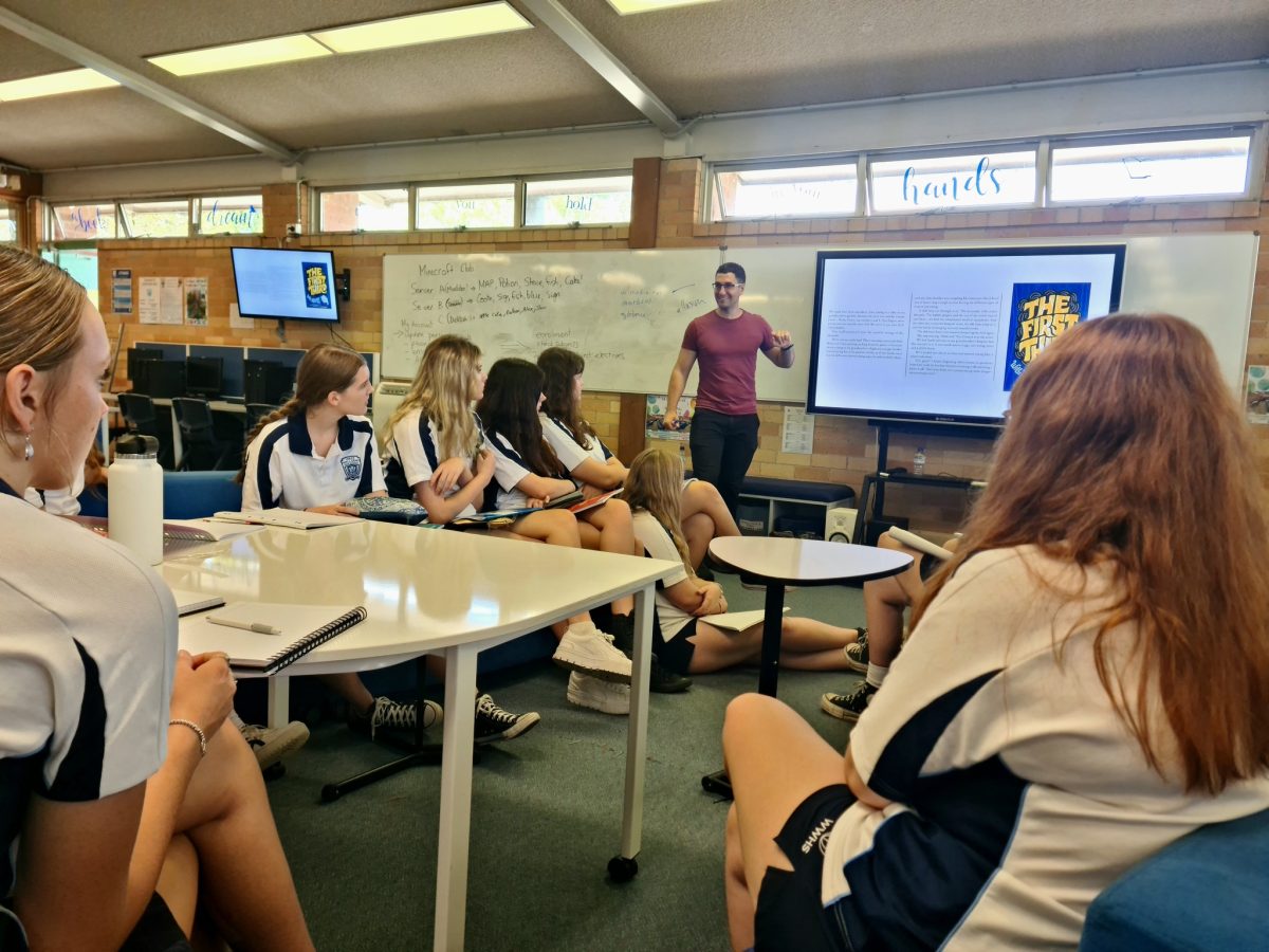 Man speaking to a group of high school students