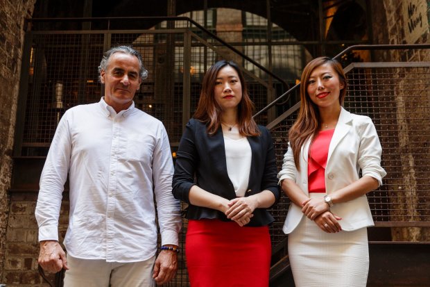 The Atlas Advisors executive team (from left):Guy Hedley, Fiona Zhuang and Jade Bao standing in front of brick building..