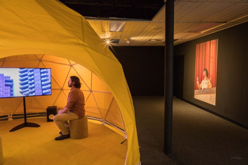 Man sitting inside The Ambassador exhibition at Bega Valley Regional Gallery.