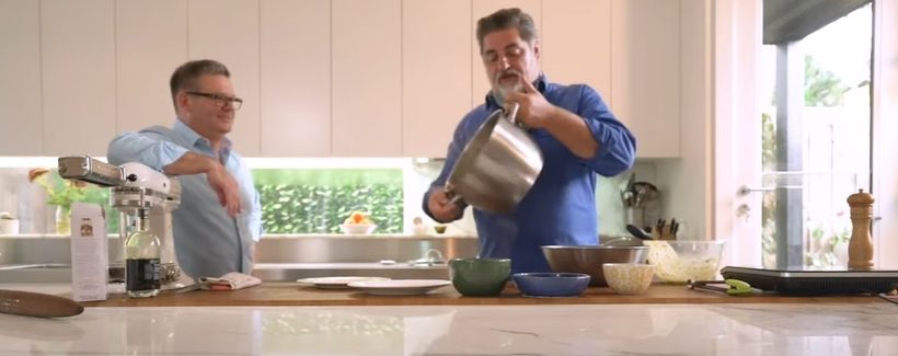 Celebrity chefs Gary Mehigan (left) and Matt Preston (right) cooking in kitchen.