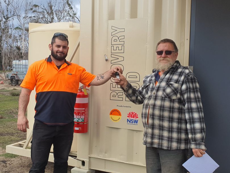 Resident being handed keys to recovery pod at Nerriga.