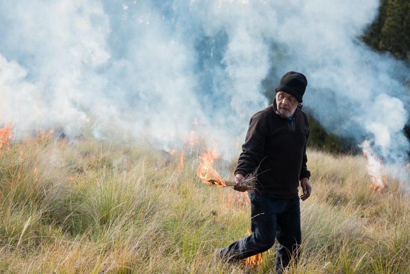 Aboriginal elder Uncle Les Simon conducting a traditional burn on private land in Meringo.