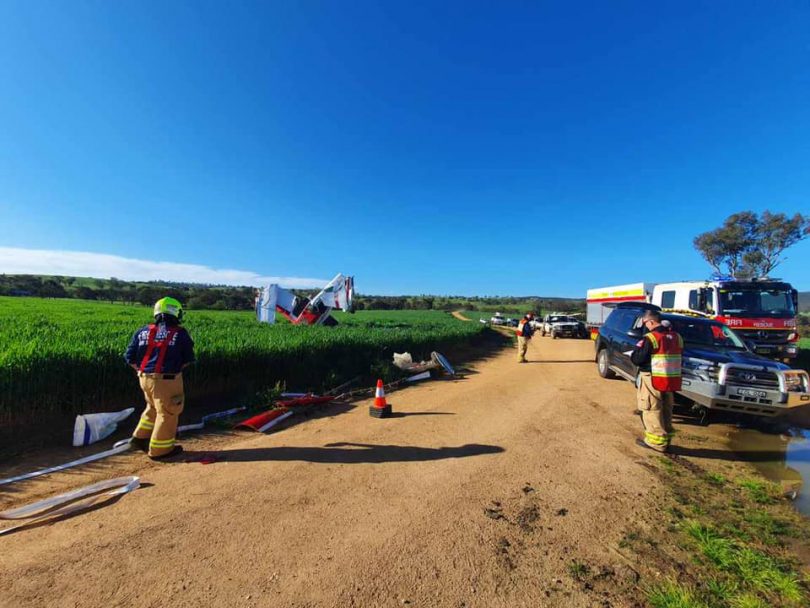 Emergency services crew at scene of light plane crash in a Cootamundra paddock.