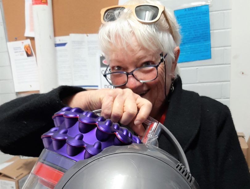 Caroline Long holding Dyson vacuum cleaner.