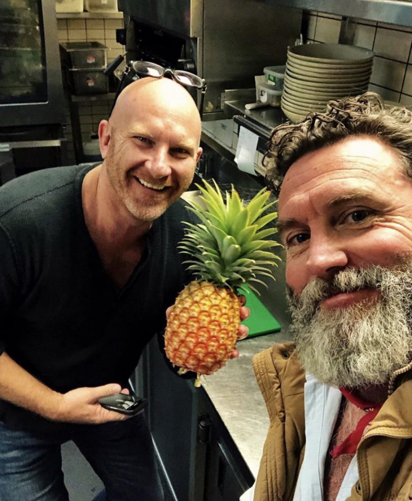 Charlie Arnott with chef Matt Moran, who is holding pineapple.