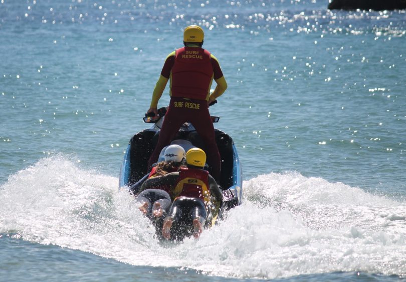 Surf lifesavers training on jet ski.