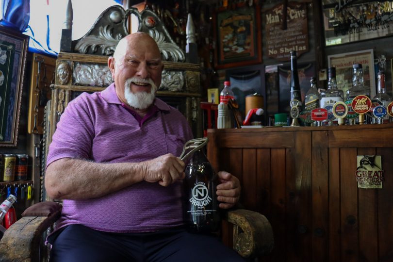 Dennis Harrison with his bottle opener collection.