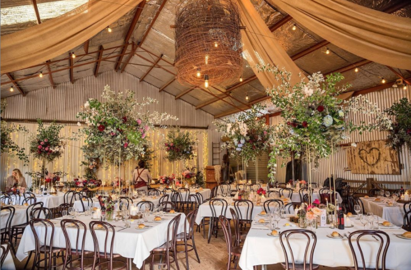 Flowers and fairy lights hang from shearing shed at Bushfield Farm.