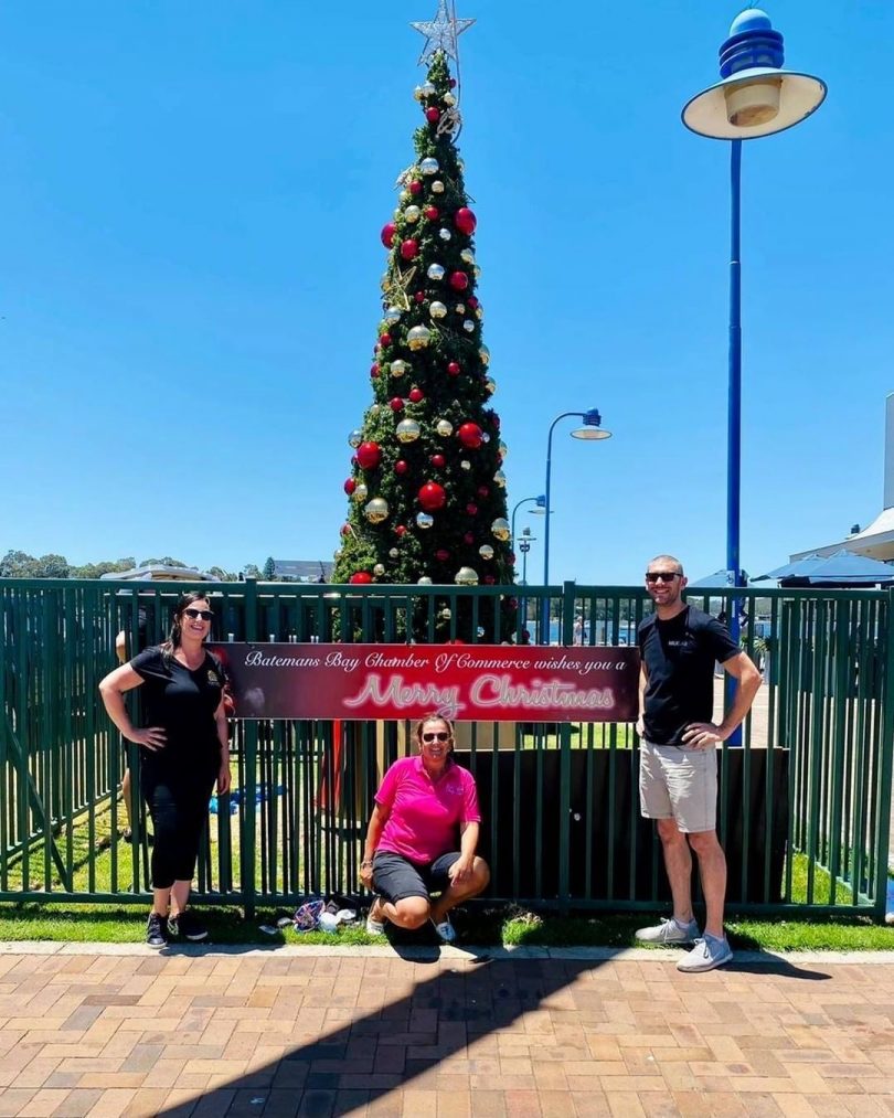 Rebecca Mahon, Marieke Janssen and Mathew Hatcher in front of Christmas tree.