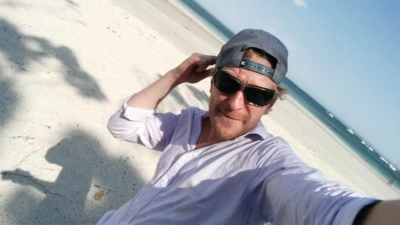 Luke Moore on a beach.