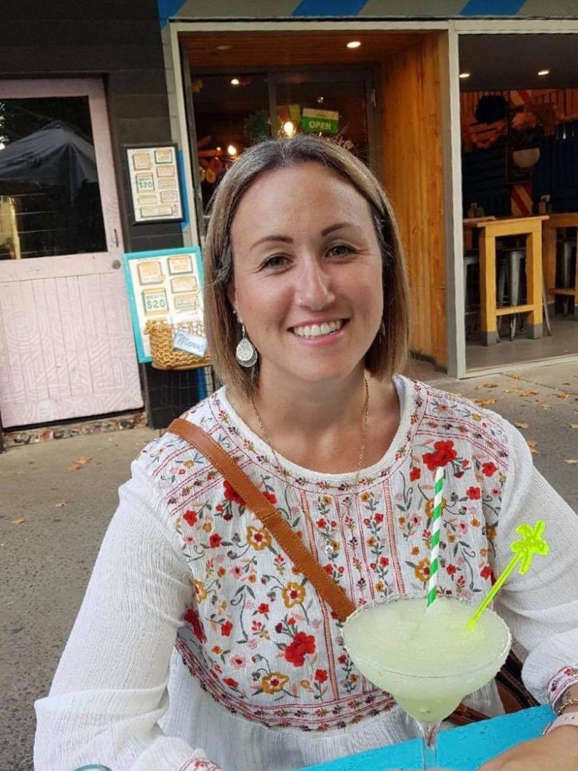 Hayley Snape smiling with a cocktail.