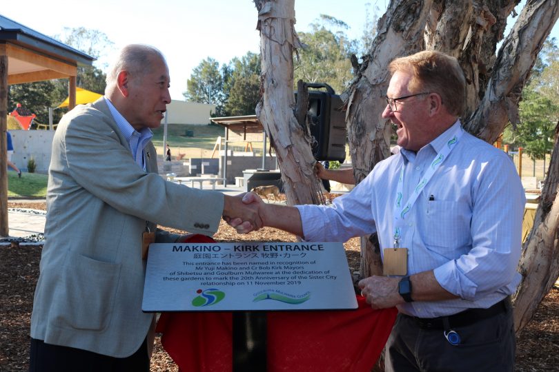 Yuji Makino and Bob Kirk shaking hands at Shibetsu Gardens.