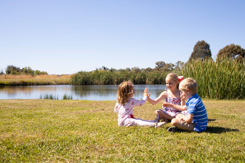 Children playing outdoors on rural property