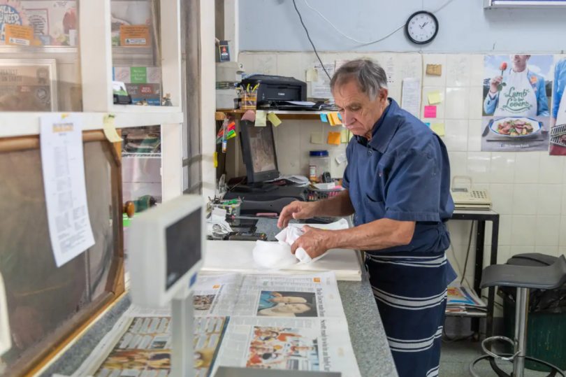 Mick Dal Santo wrapping meat in newspaper at Binalong Butchery