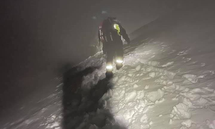 Fire and Rescue NSW rescuer hiking through snow at night in Kosciuszko National Park