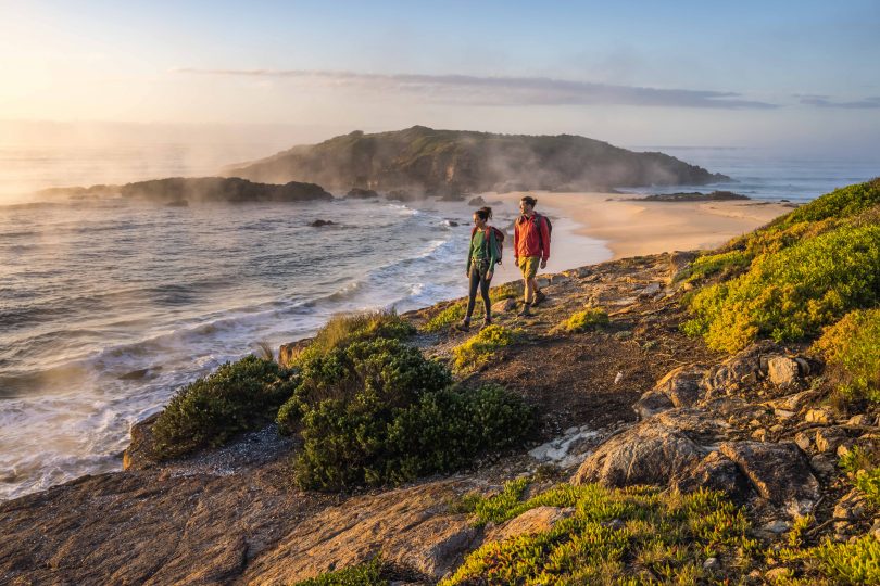 Two people walking the Wharf to Wharf Walk on NSW South Coast