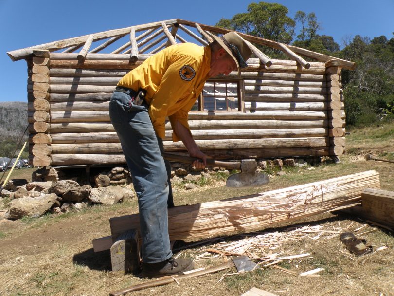 NPWS officer Peter Scobie squaring off a split slab with a broad axe