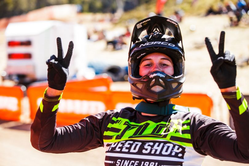 lady giving piece signs in motorbike rider clothes