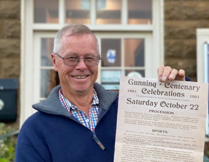 John Shaw holding Gunning centenary flyer