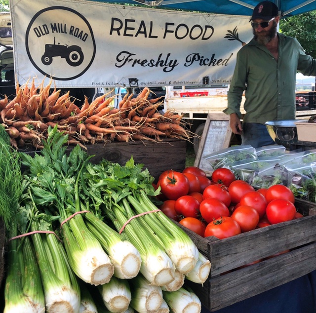 Fraser Bayley from Old Mill Road Farm shows off fresh produce at SAGE Farmers Market in Moruya