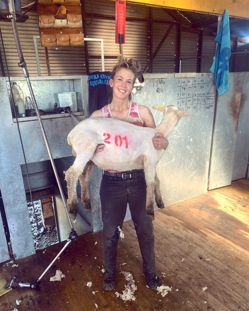 Woman holding sheep