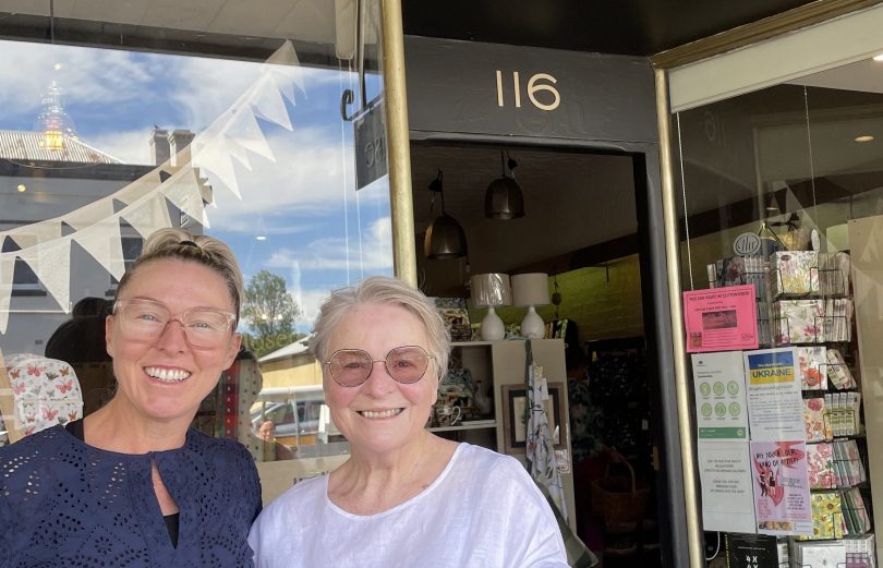 Two women outside shop