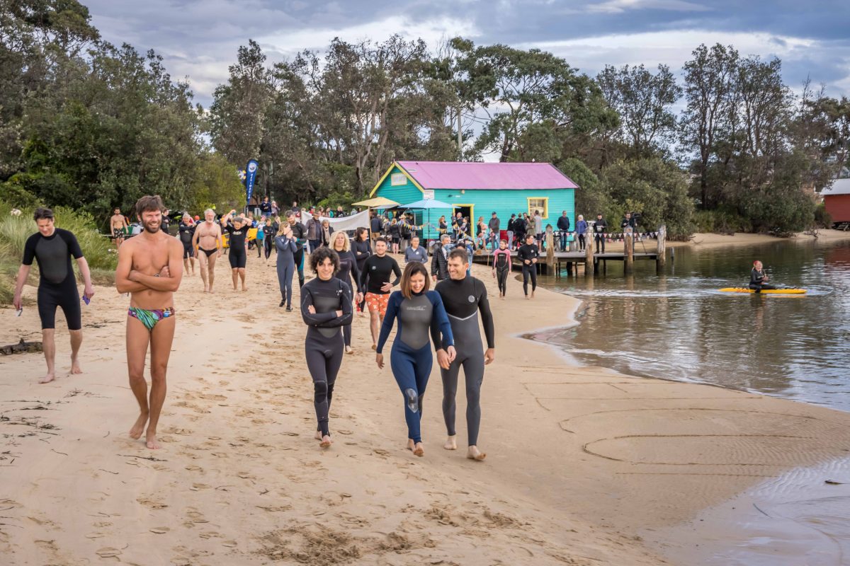 Swimmers walking along the shore