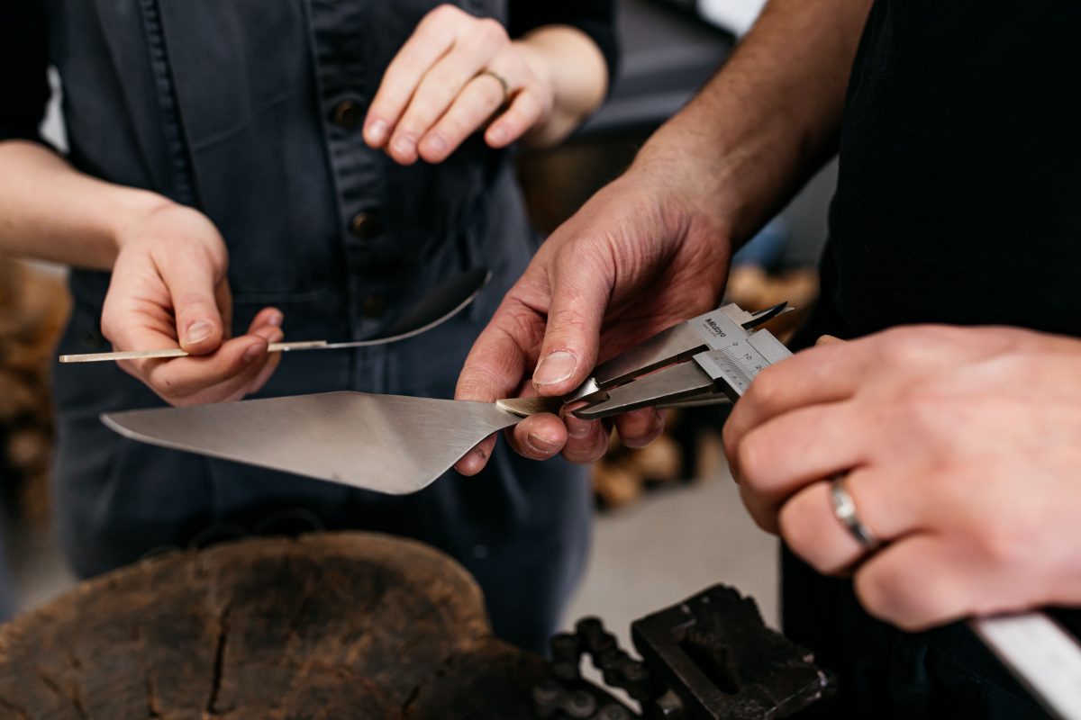 Hands working on metal