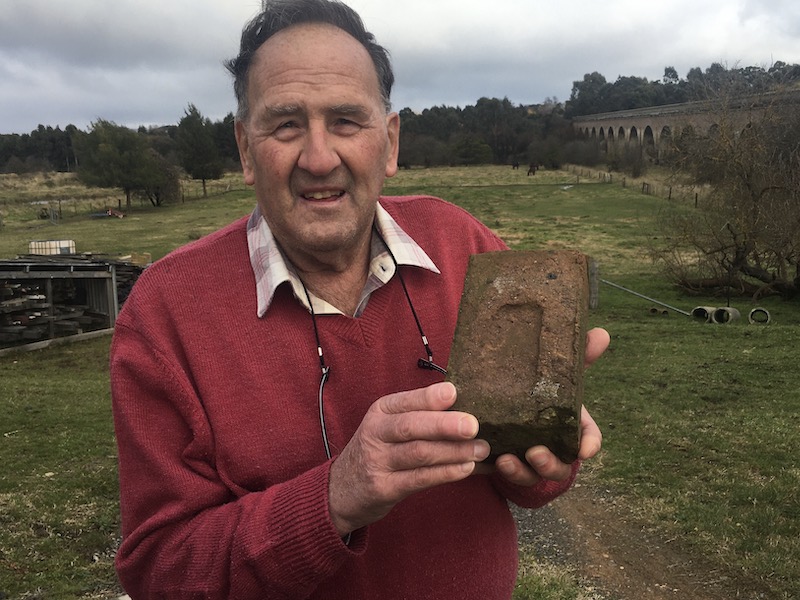 Man holding a brick