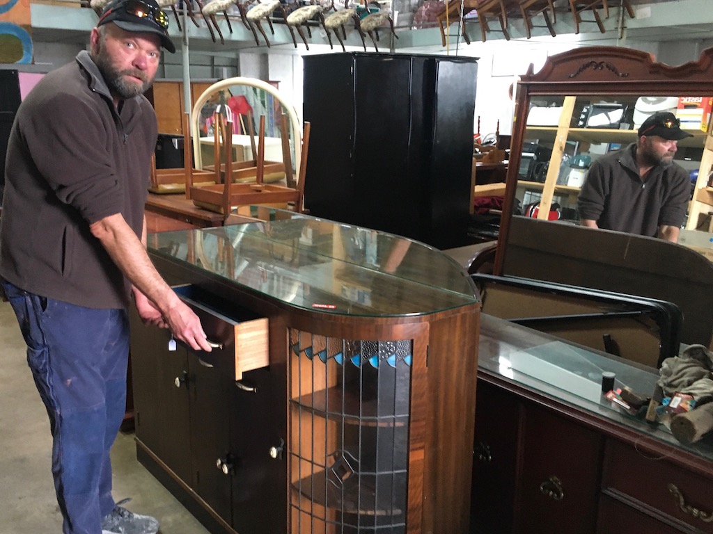 Man with display cabinet