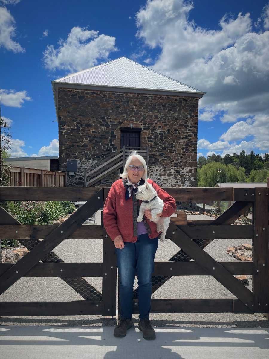 Woman in front of stone house