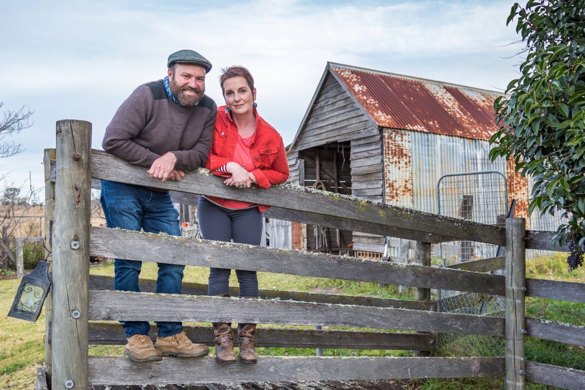 man and woman on fence