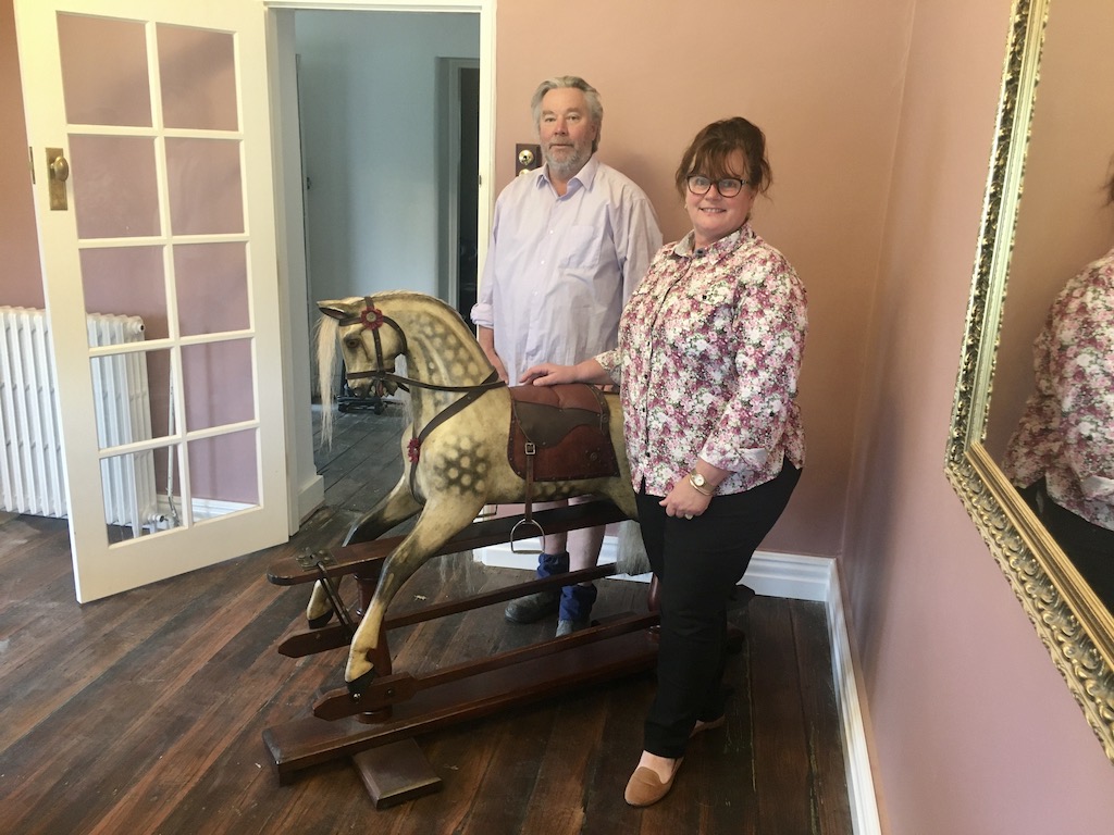 man, woman and rocking horse