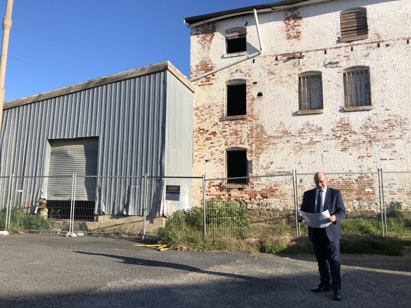 Man standing in fron of old building