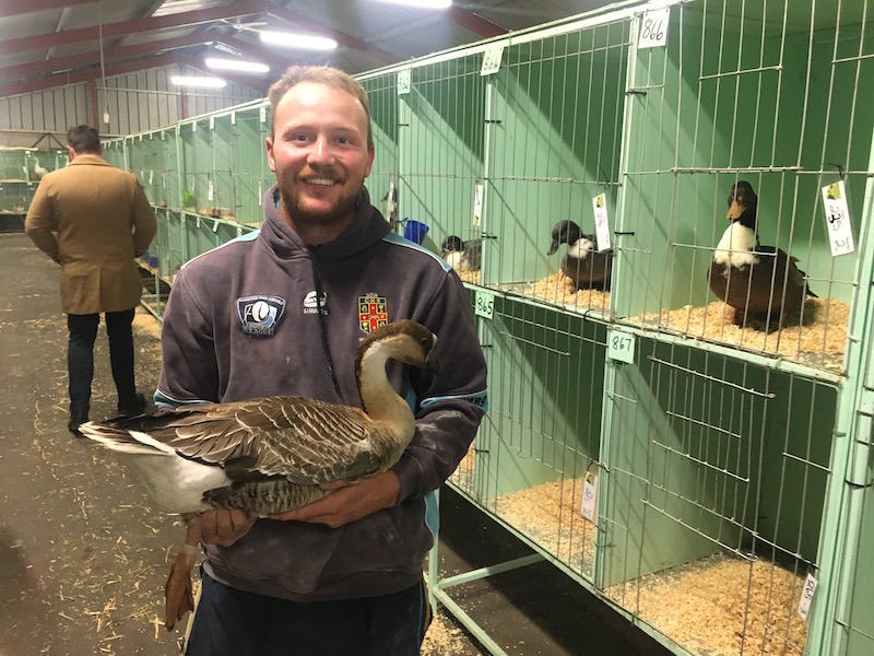 man holding goose