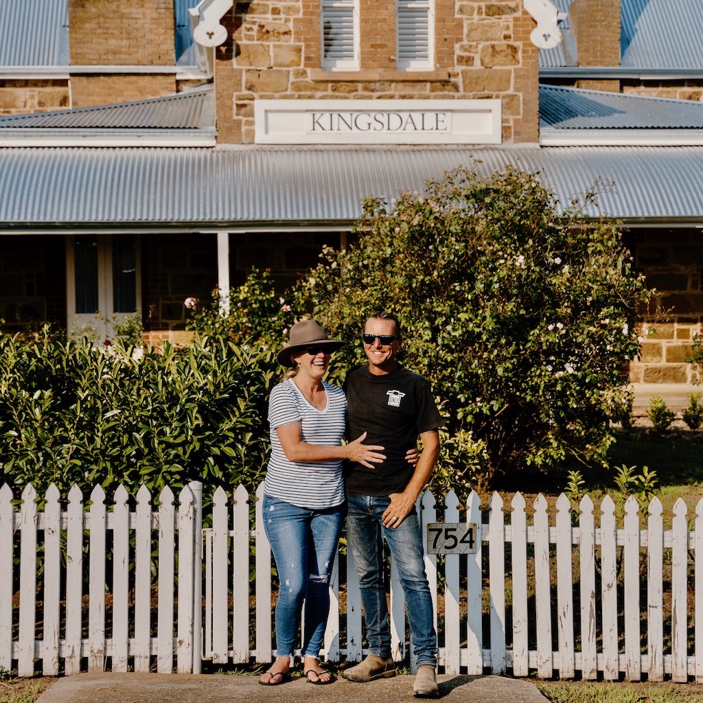 man and woman in front of house