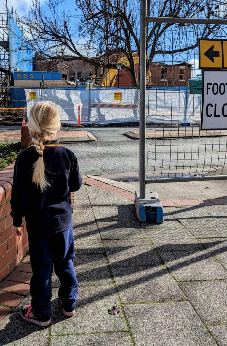 Child looking at demolition work 