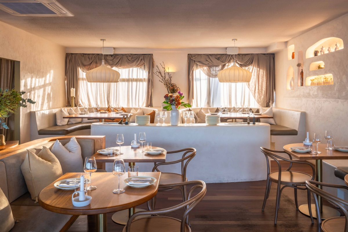 A beautiful white and beige dining room at a restaurant