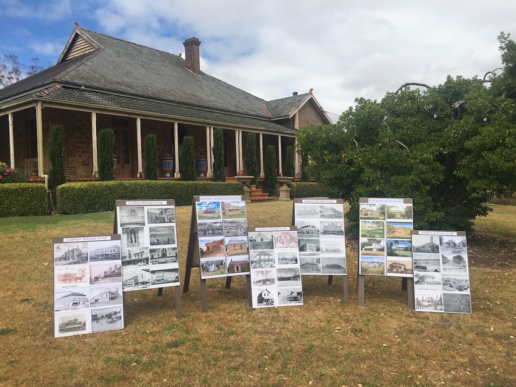 photo display in front of historic house