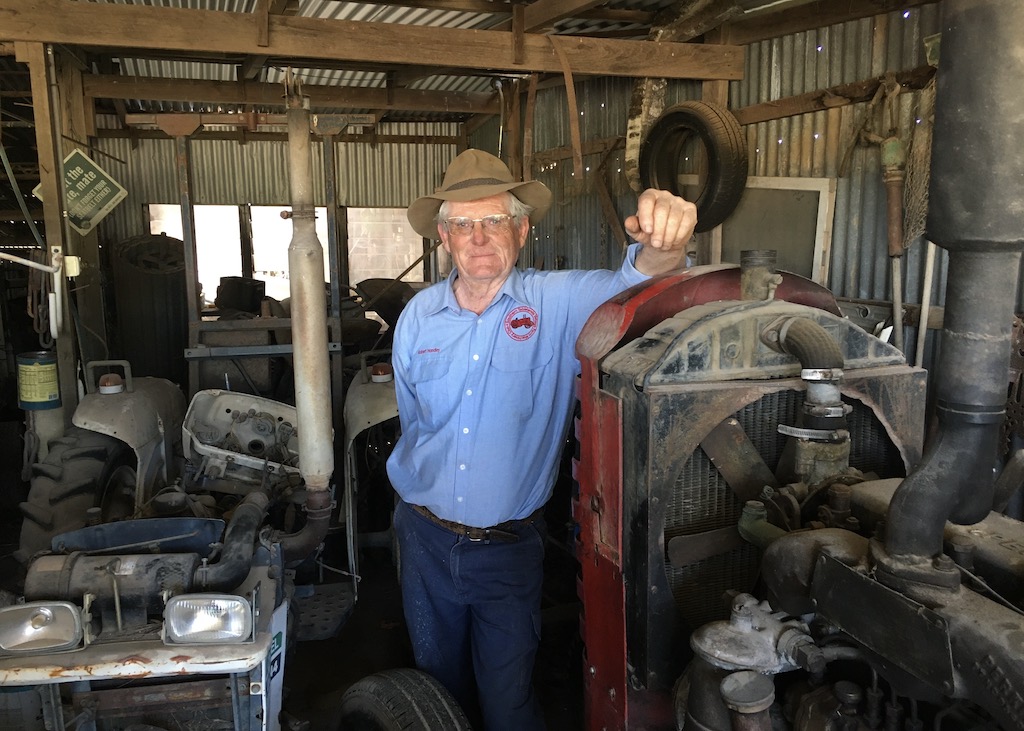 man with tractor in his shed