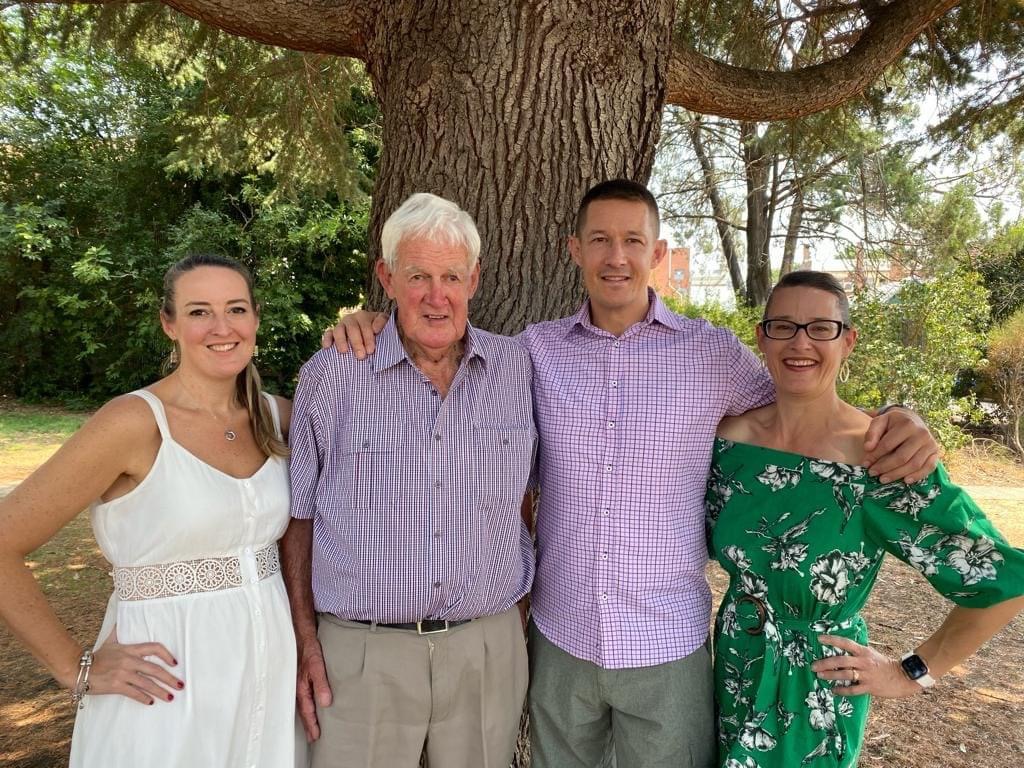 Group of four people under a tree